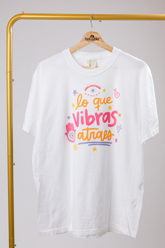 white t-shirt with orange and pink text and graphics on a plain background