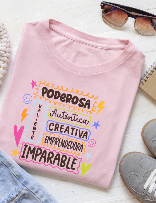 Pink t-shirt with motivational text on a white surface with sunglasses and shoes.
