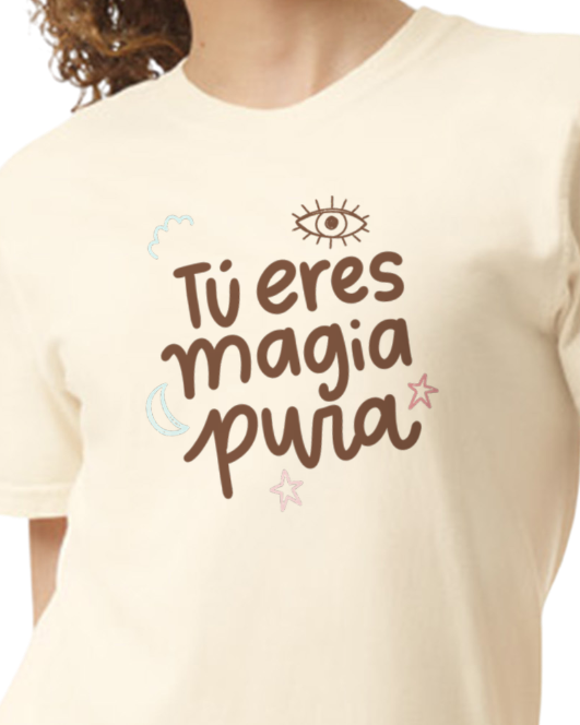 Beige t-shirt with brown text and graphics on a plain background