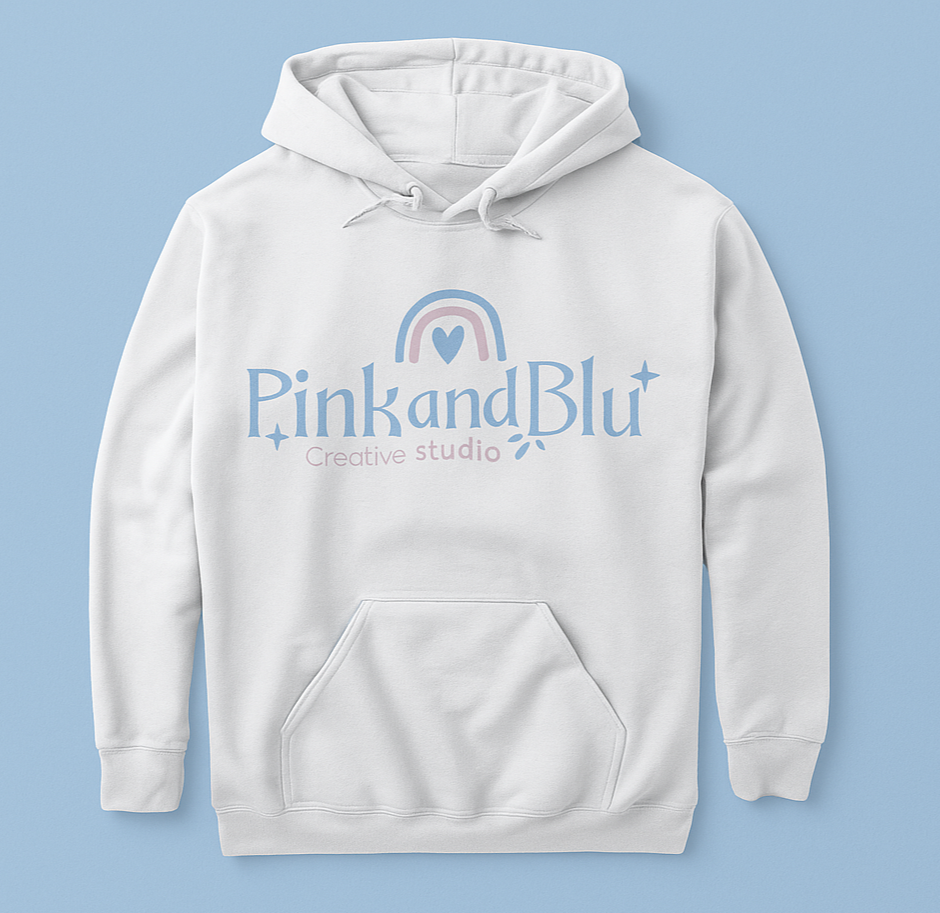 White hoodie with 'Pink and Blu Creative Studio' logo on a light blue background