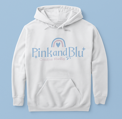 White hoodie with 'Pink and Blu Creative Studio' logo on a light blue background