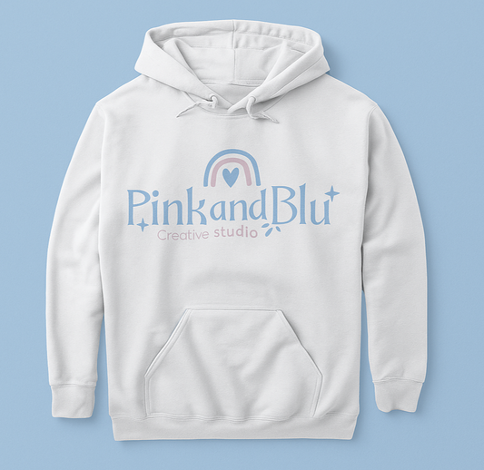White hoodie with 'Pink and Blu Creative Studio' logo on a light blue background