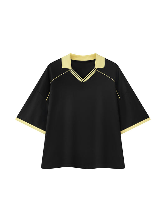 A black short-sleeve top with a V-neck collar and sleeve cuffs in pale yellow, featuring thin yellow piping details on the shoulders and collar, shown against a plain white background.