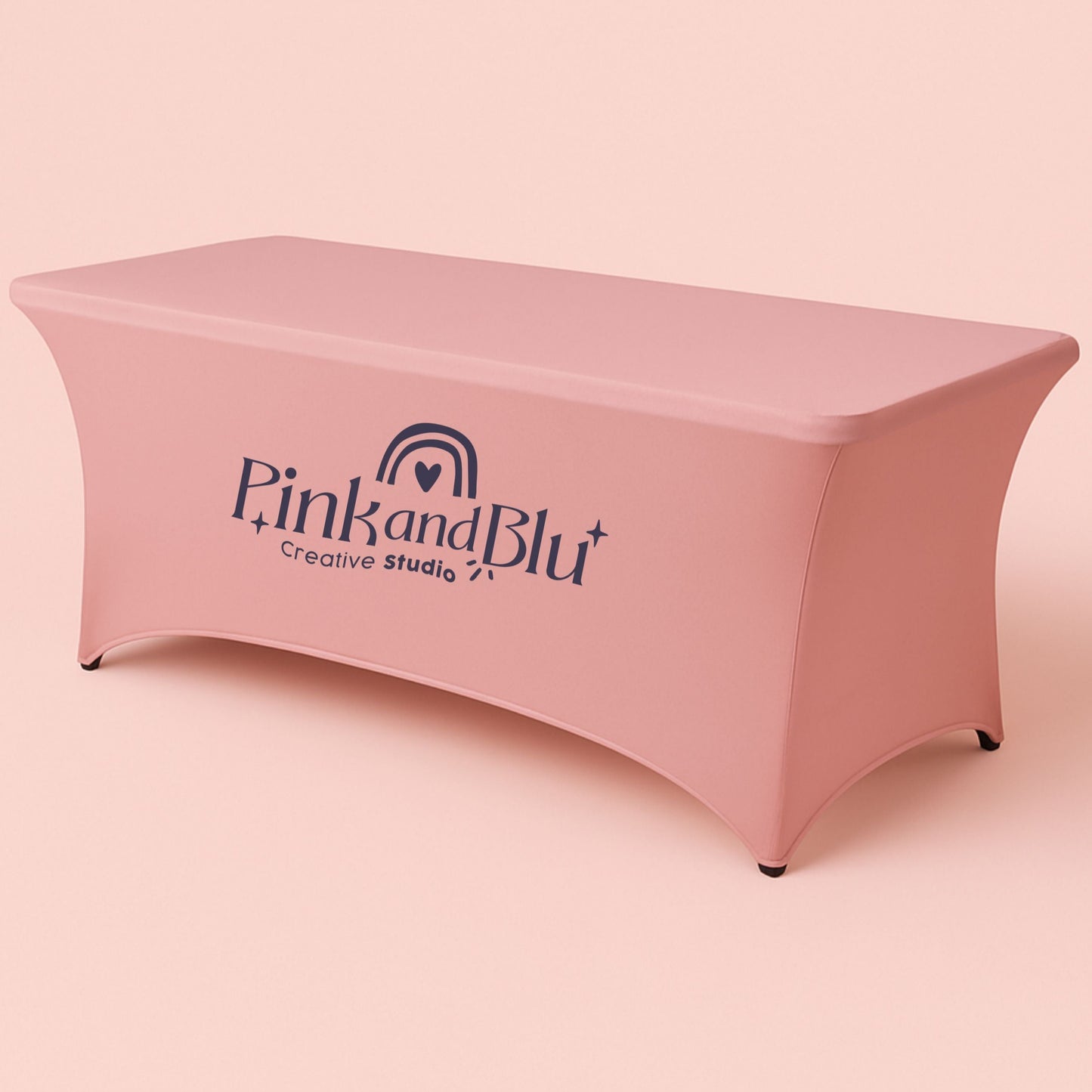 Pink table cover with 'Pink and Blu' logo on a matching pink background