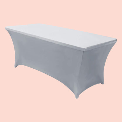 Gray fitted tablecloth on a rectangular table against a pink background