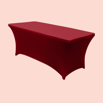Red tablecloth on a rectangular table against a beige background