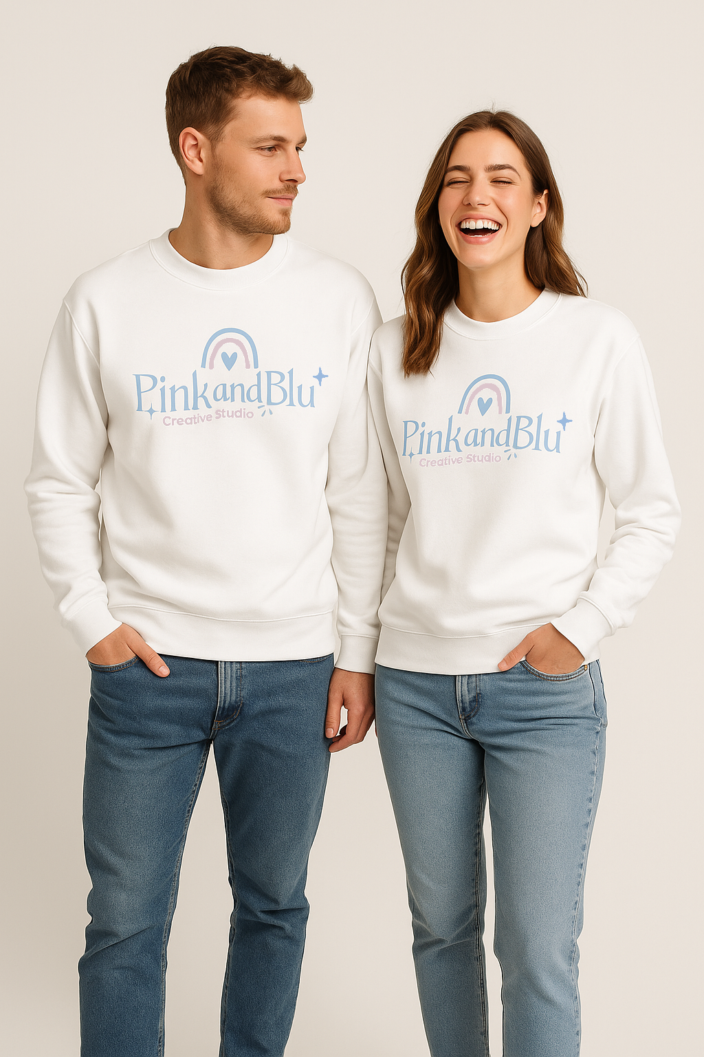 Two people wearing white sweatshirts with 'PinkandBlu' logo on a plain background