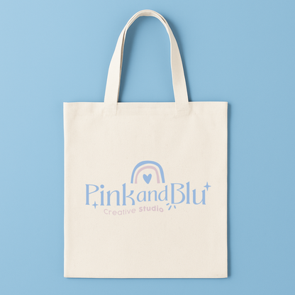 Tote bag with 'Pink and Blu Creative Studio' logo on a blue background