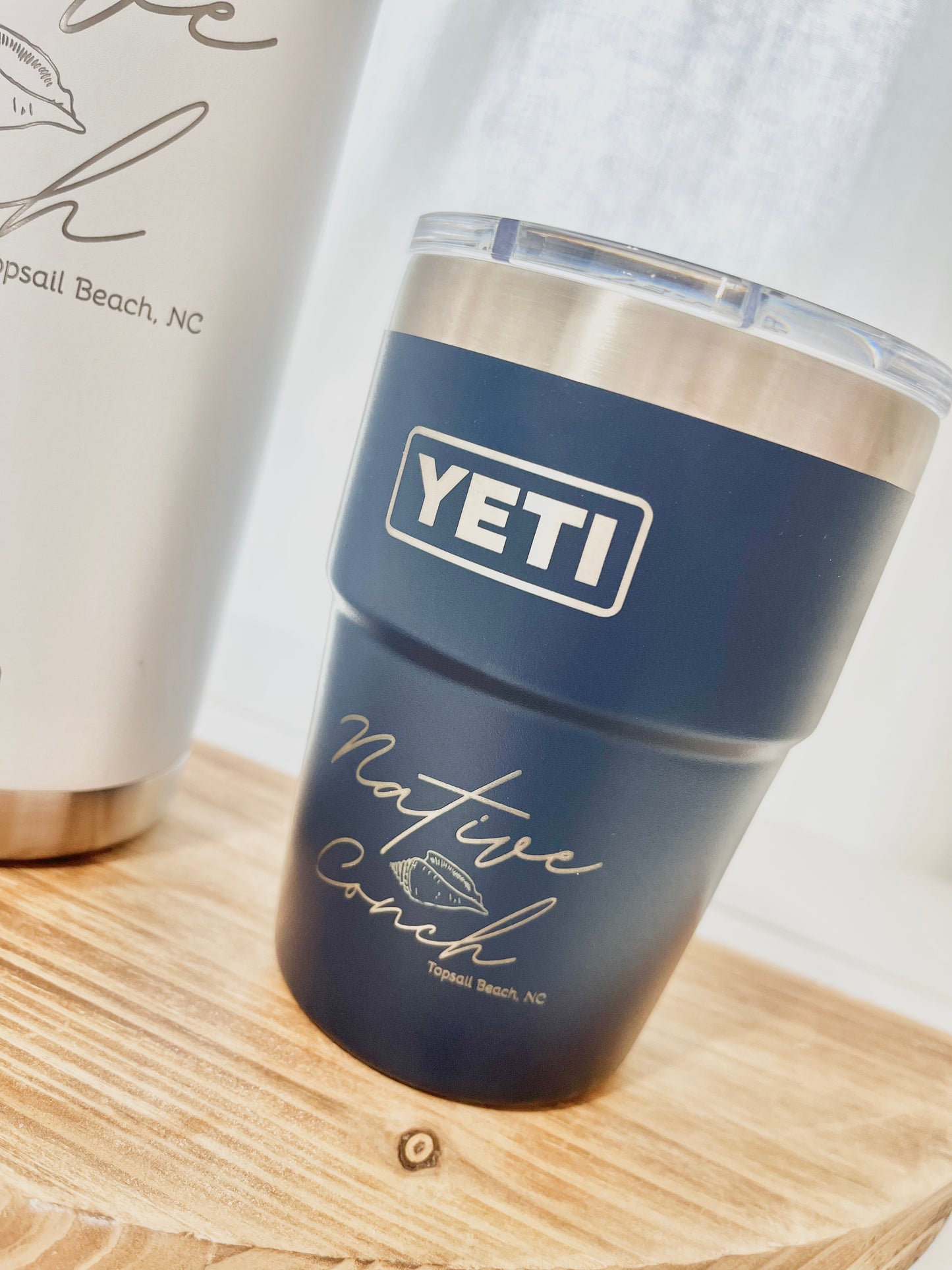 Blue YETI mug with 'Native Couch' text on a wooden surface